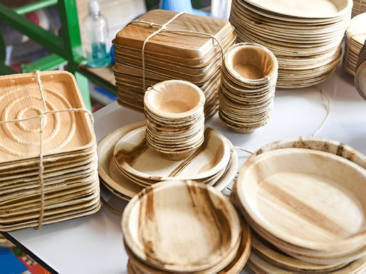 Stacks of eco-friendly palm leaf disposable plates and bowls in different shapes and sizes