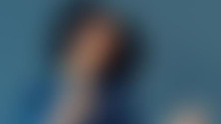 A woman points and smiles.