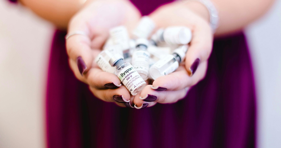 A woman's hands holding Dysport and Botox bottles.