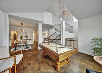 A staged room with a pool table.