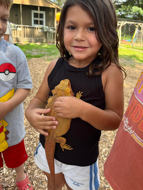 David Parides' daughter holds a reptile.