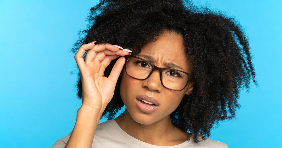 Woman adjusting glasses with a skeptical expression, representing the questions clients should ask before hiring an AI content agency.