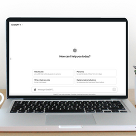 A laptop on a desk with ChatGPT open.