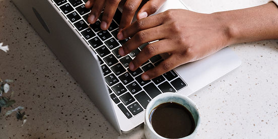 Hands typing on a computer