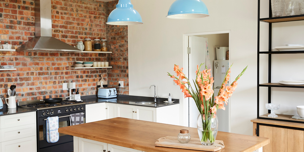 A bright kitchen with flowers on the kitchen table in a Hudson Valley home.