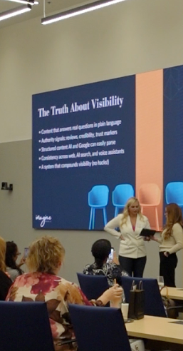 A group of people in an AI workshop led by Michele Biaso, who is showing a student something on an iPad.