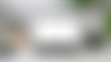 A computer on a desk with ChatGPT on the screen and a mug with an Imagine Social logo.