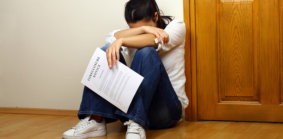 A woman holding a foreclosure notice with her head down.