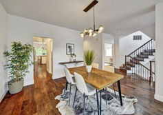 A dining area with an overhead light that lights up the staged table.
