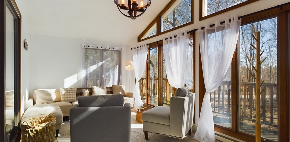 A living room with large sliding glass doors in the Poconos.