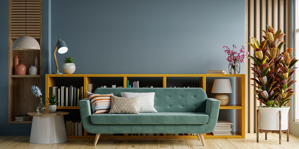 A living room showing a light teal couch and a bookcase behind it.