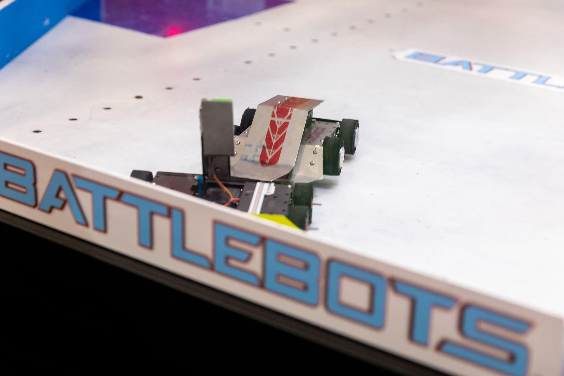 Miniature robot inside BattleBots combat arena at experiential booth