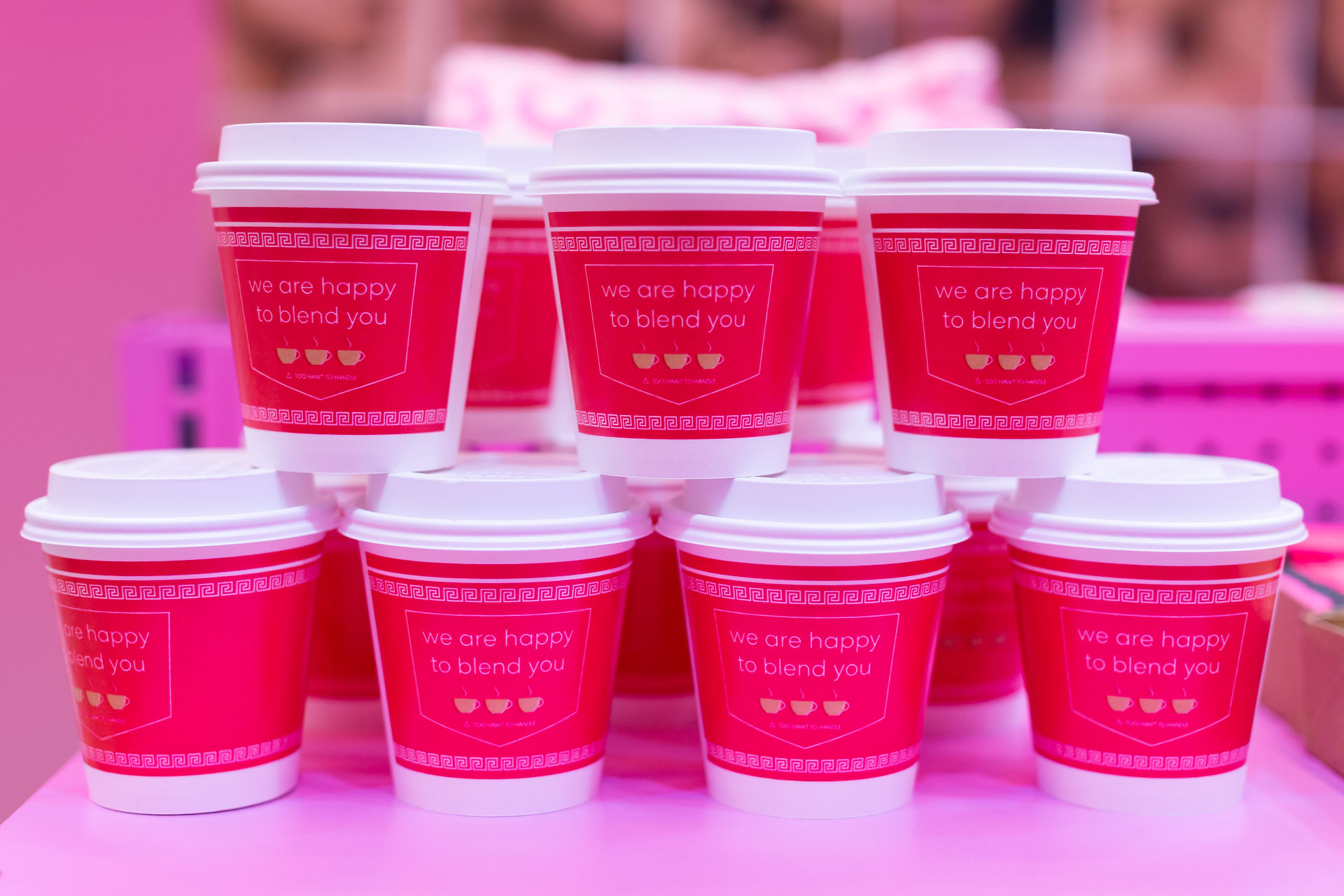Beautyblender pink coffee cups with "we are happy to blend you" slogan.