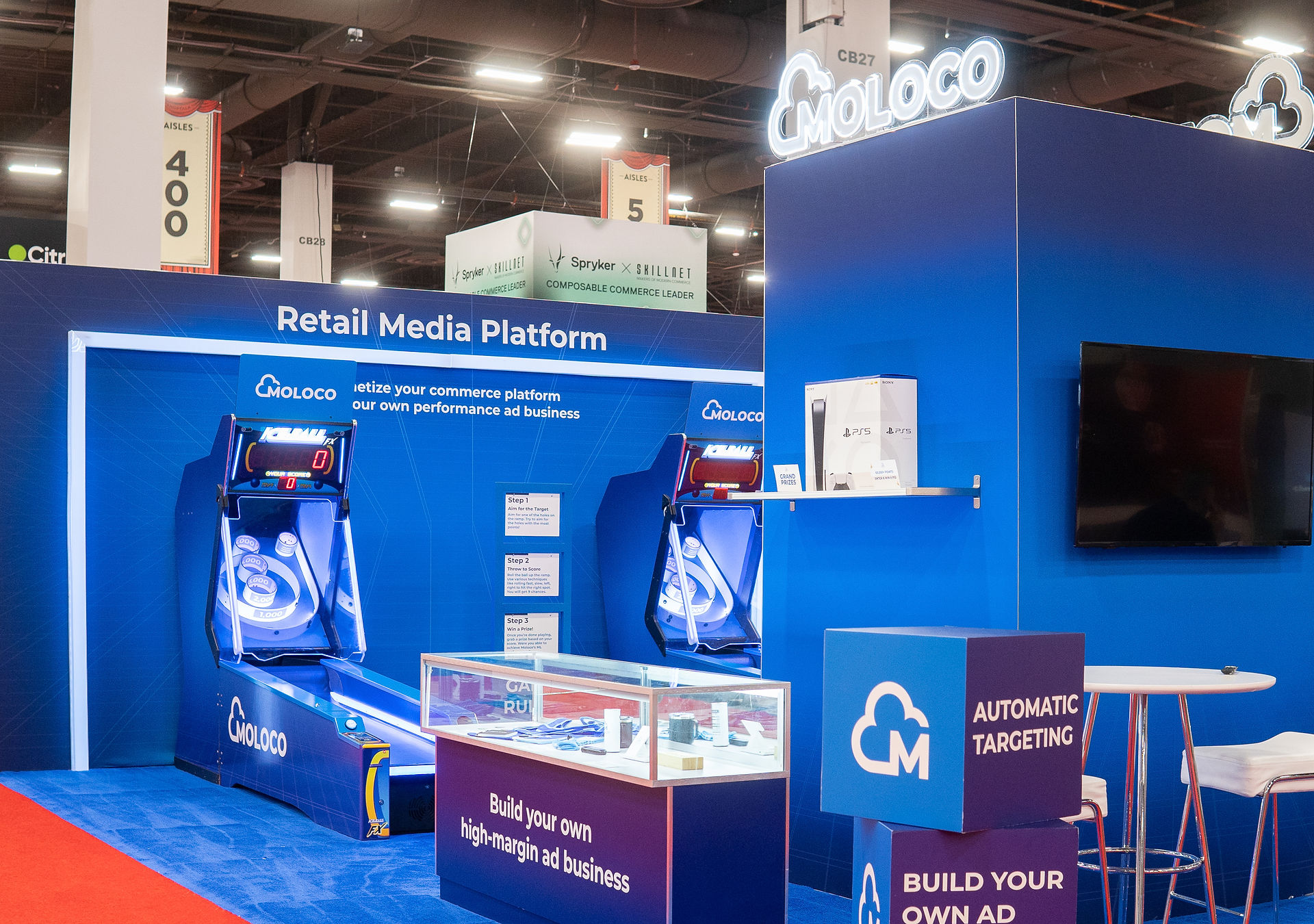 Custom tradeshow booth with arcade games, brand messaging, and prize display