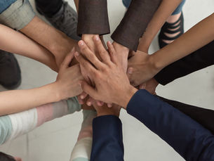 A group of young people holding hands together