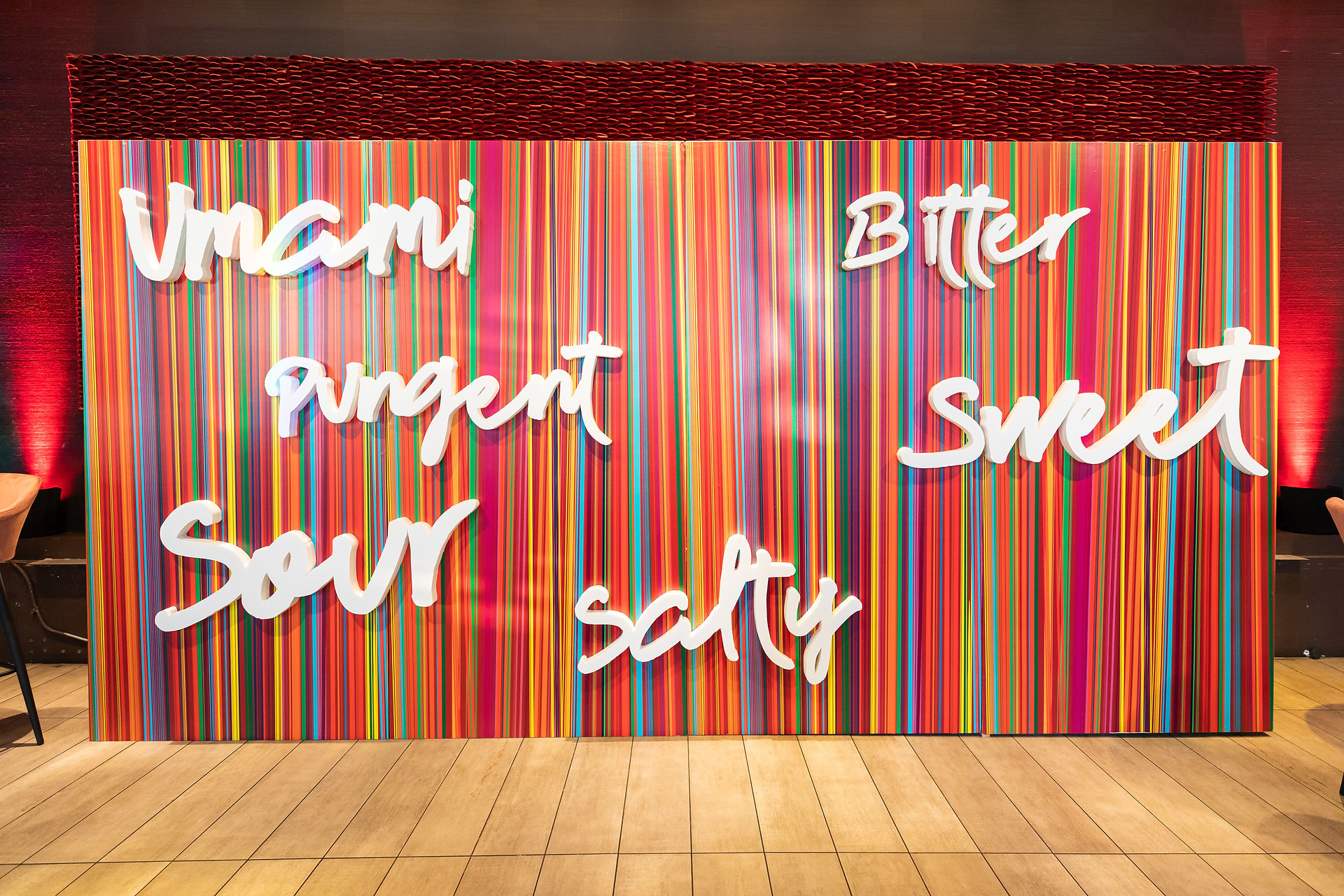Colorful photo backdrop with culinary-themed words for event photo opportunities