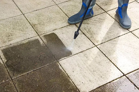 One of our cleaners expertly pressure washing patio