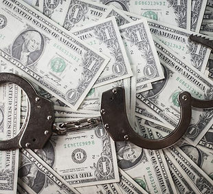closeup-shot-metal-handcuffs-dollars_181624-27693.jpg