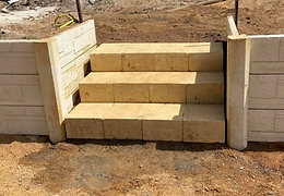 Panel and post retaining wall and stairs