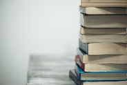 A cosy illustrated scene of a child reading in a golden-lit library on Bookdio.org