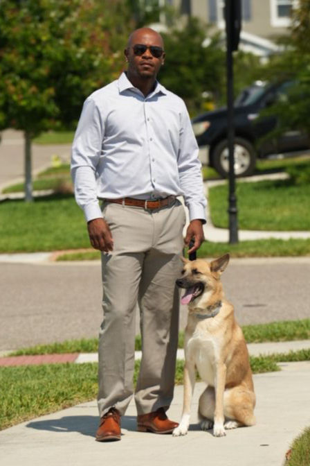 Eye-level view of a dog trainer working with a dog on leash control