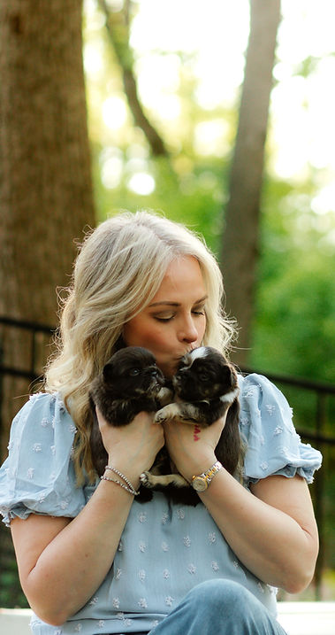 Kelly Sabo snugging with her two fluffy French bulldogs