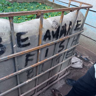 White tank with Be Aware, Fish, and Be written on it.