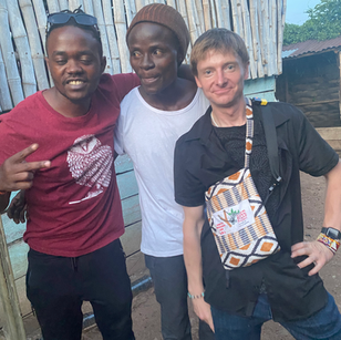 Three men smiling, posing together; Speakers for Africa Uganda nonprofit promoters.