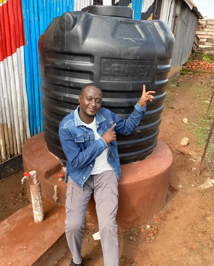 Gracious sitting by water tank