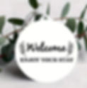 Round welcome tag with text Enjoy Your Stay and eucalyptus.