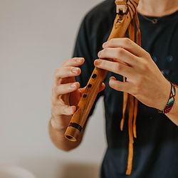 Instructor playing Native American flute during group sound bath healing session