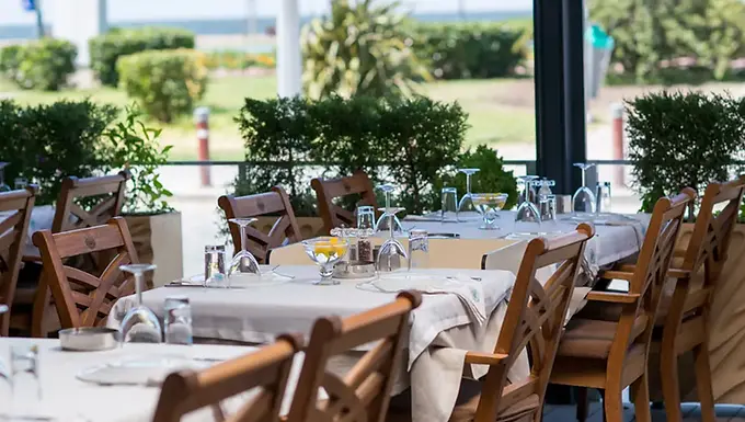 Sea-facing dining terrace with set tables at İzmir Deniz Restaurant in Alsancak, İzmir.