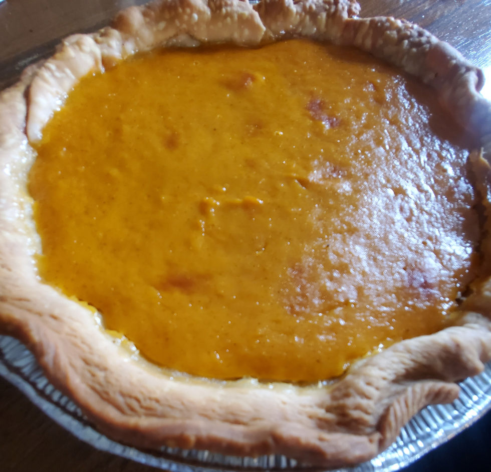 Freshly baked pumpkin pie in a foil tin, ready to serve.