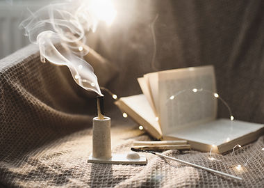 Palo Santo stick on fire with smoke in a beautiful candlestick. Healing, meditation, relax