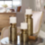 Three gold candle holders with lit candles on a table, home decor Inspirations Raleigh