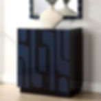 A navy blue cabinet, with a decorative design and a white vase on top
