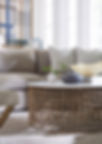 Sofa with pillows, table, vases, Lars Coffee Table, and decorative artwork in room.