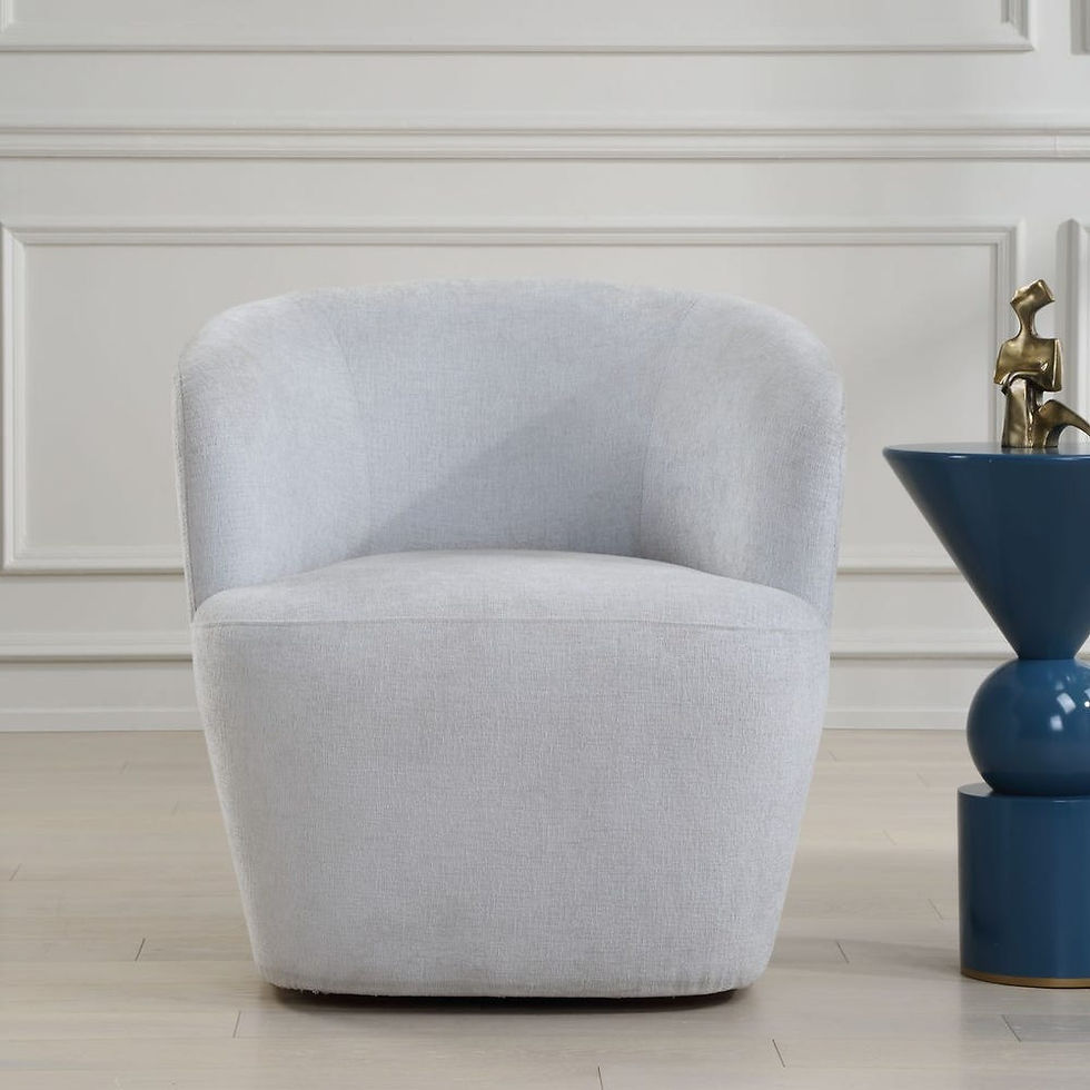 Light blue upholstered Mist Swivel Chair against white wall and blue table.