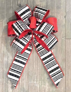 Decorative black and white striped bow with red ribbon and The Art of Bow Making-Holiday Edition.