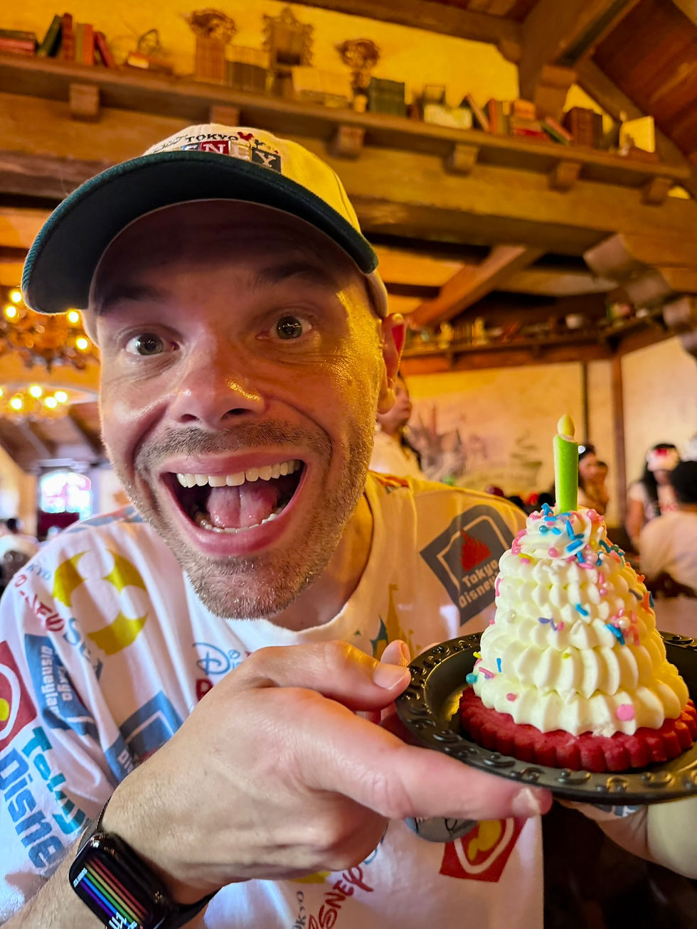 Ed grins while holding Disneyland's 70th Stuff dessert at Red Rose Taverne during his birthday celebration.