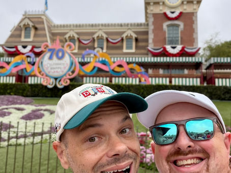 Ed and Jason Danielak smile together outside Disneyland during the park’s 70th anniversary celebration on Ed’s birthday trip.