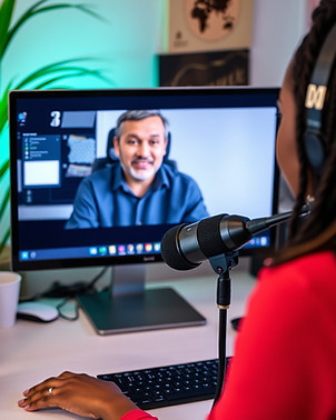 Black woman with mic interviewing a white man on her computer screen.jpg