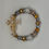 Thumbnail: Gold, silver, clear, colored beading with gold cross Forgiven Bracelet.