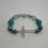 Thumbnail: Turquoise, silver, gold beading with silver cross Forgiven Bracelet.