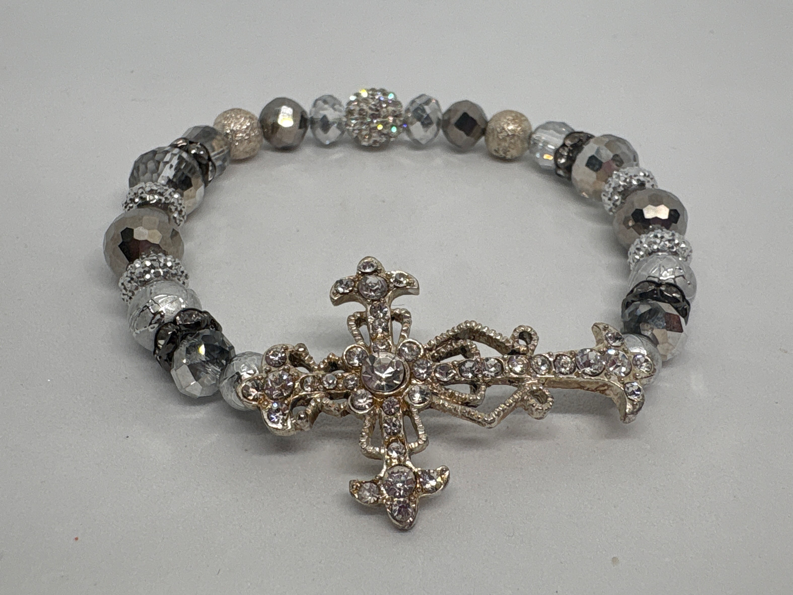 Clear, silver, gold beading with silver/ gold cross Forgiven Bracelet.