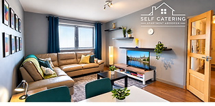 View of leather sofa, smart TV and dining table