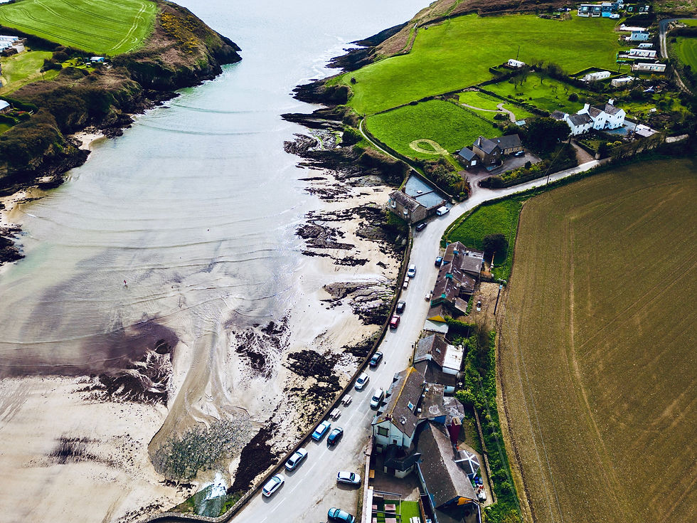 Panoramic view of Ireland's coastline, showcasing golden sands, deep blue waves of the Atlantic, and the silhouette of an ancient castle perched on a distant cliff, embodying the diverse beauty and history of the Emerald Isle's beaches.