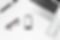white-office-desk-with-laptop-supplies-top-view-eyeglasses-watch-phone-pen-marker-notebook