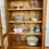 Miniature : Vitrine ancienne en bois clair, portes vitrées et cannage