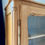 Miniature : Vitrine ancienne en bois clair, portes vitrées et cannage